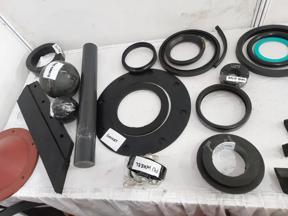 Assorted black rubber gaskets and seals laid out on a table